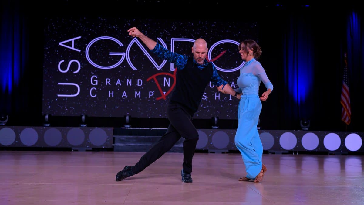 Steve leading Myers through a footwork pattern on stage at the USA Grand National Dance Championship.